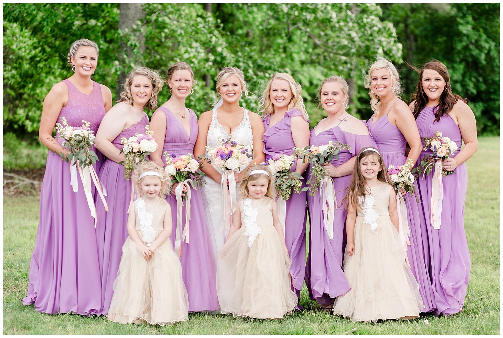 wedding bridal party with purple and gold details and bouquets
