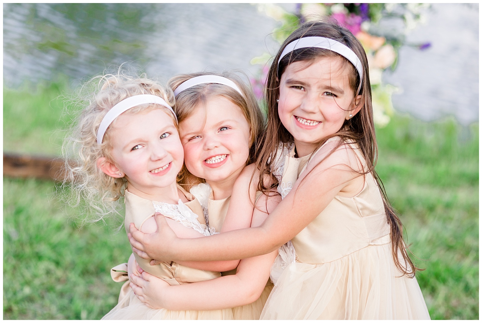 southern wedding with flower girls hugging and twirling in their flower girl dresses