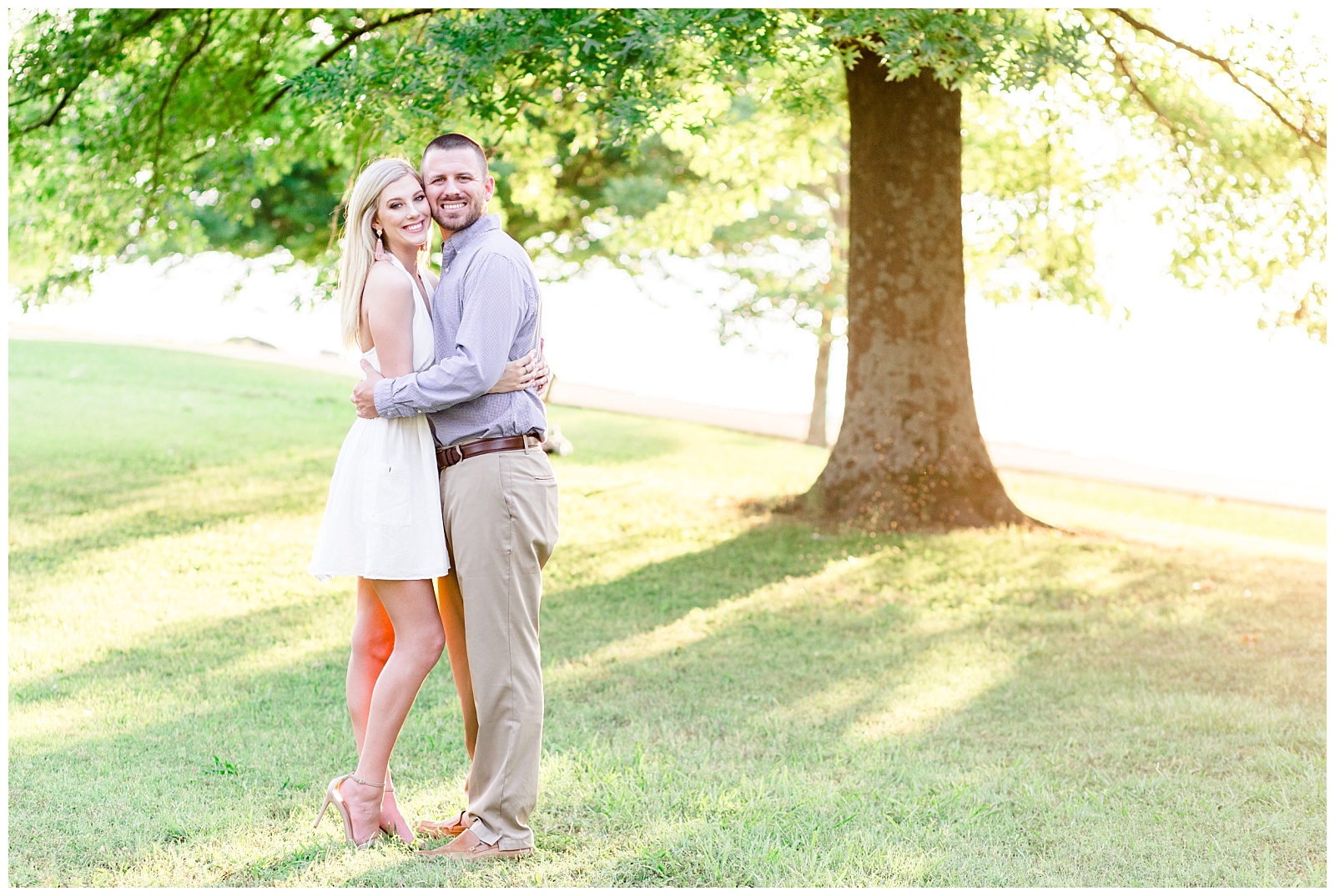 lake engagement session photo with white dress and blue shirt