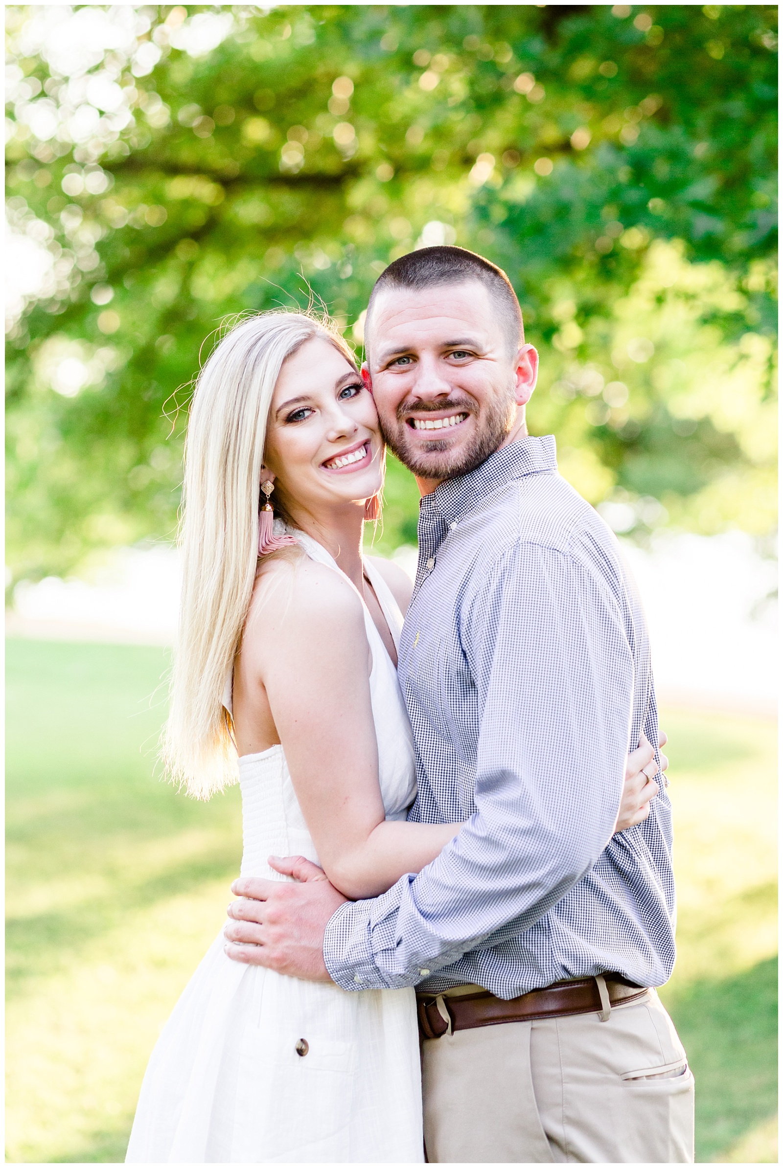 lake engagement session photo with white dress and blue shirt