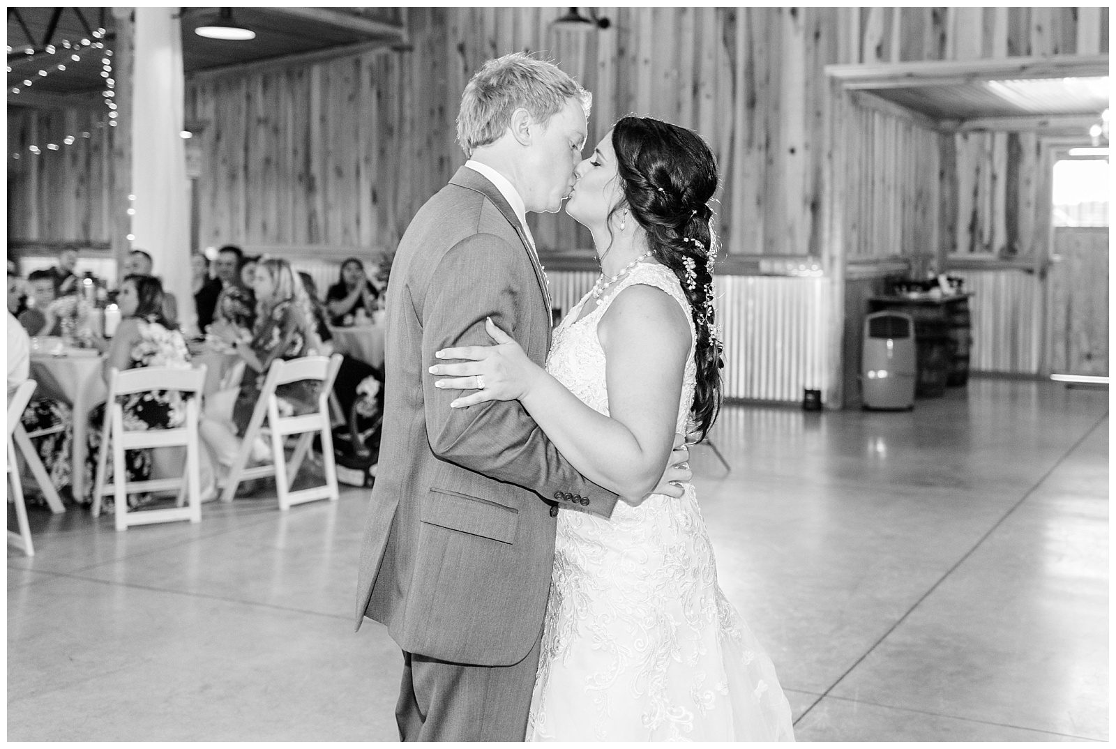 bride and groom first dance in rustic barn wedding
