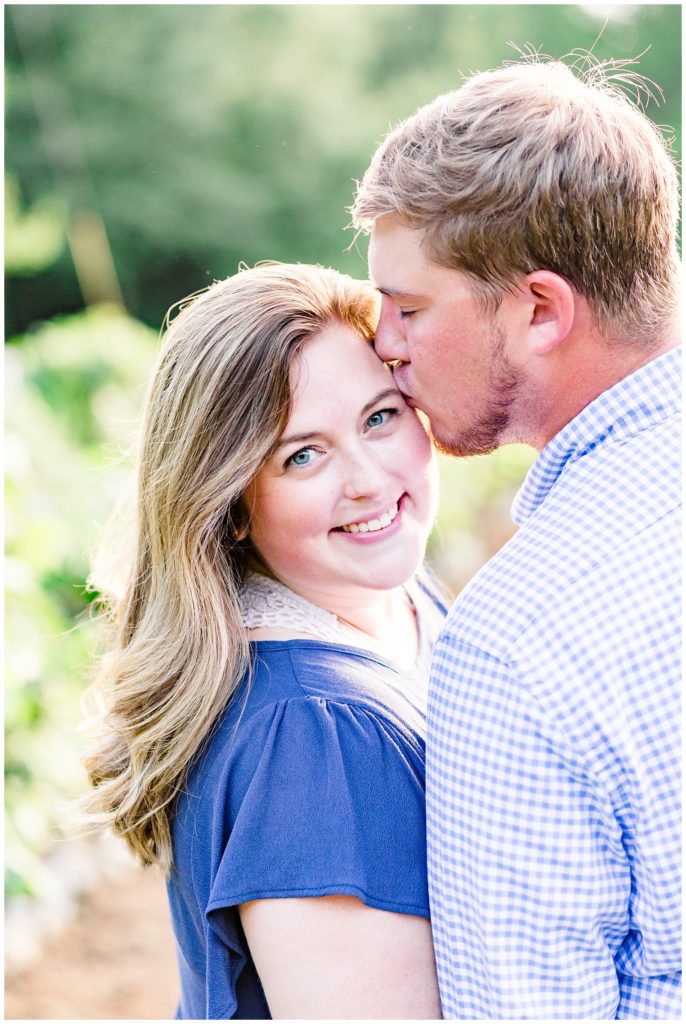 summer engagement session at plantation home in vineyard in huntsville alabama in navy outfits
