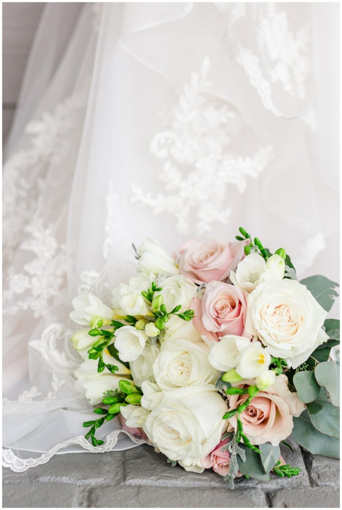 white and pink wedding bouquet by lace wedding dress