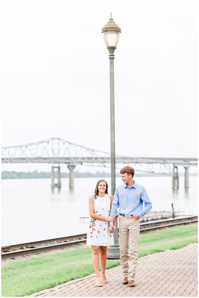 engagement session by the river with flowers with blue colors