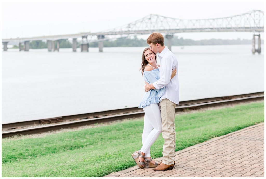 engagement session by the river with flowers with blue colors
