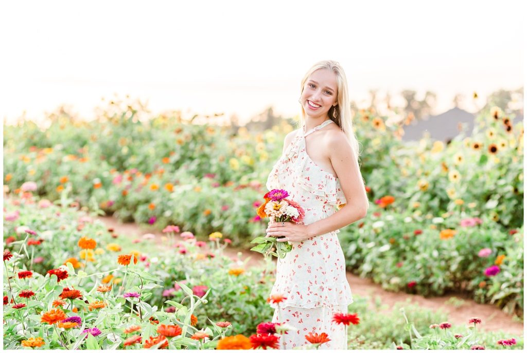 senior session in colorful flower field with floral maxi dress