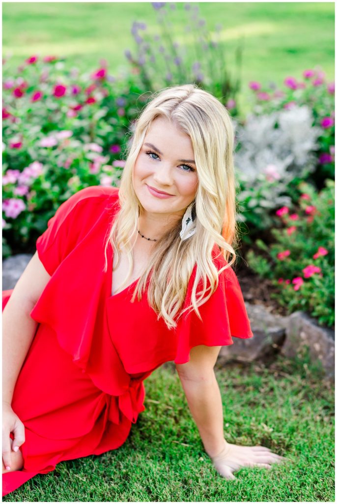 summer senior session by flowers in red romper
