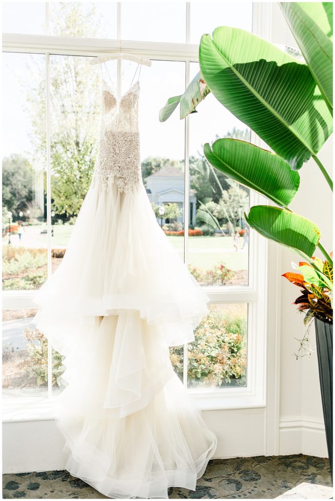 wedding gown hung up in window
