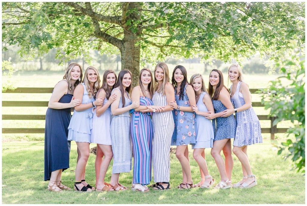 senior spokesmodel team in blue dresses and jumpsuits in field