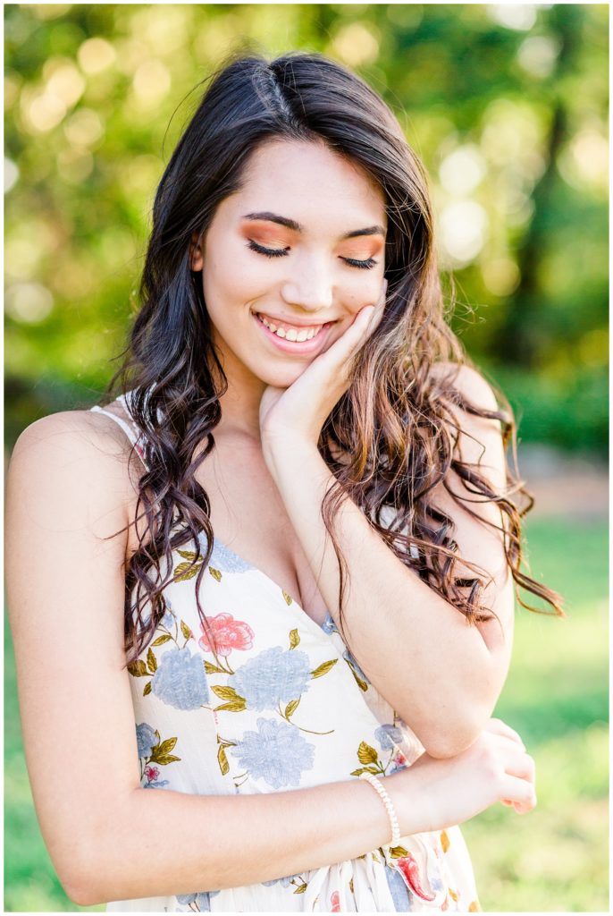 outdoor nature senior session in floral dress at sunset in greenery