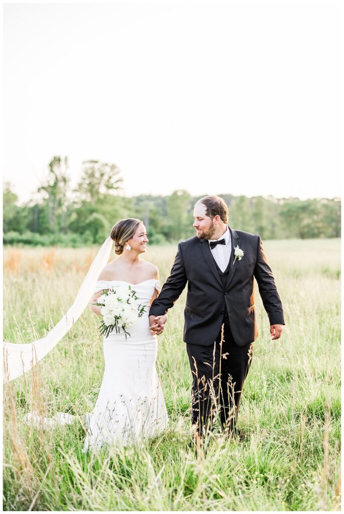 bride and groom in open field