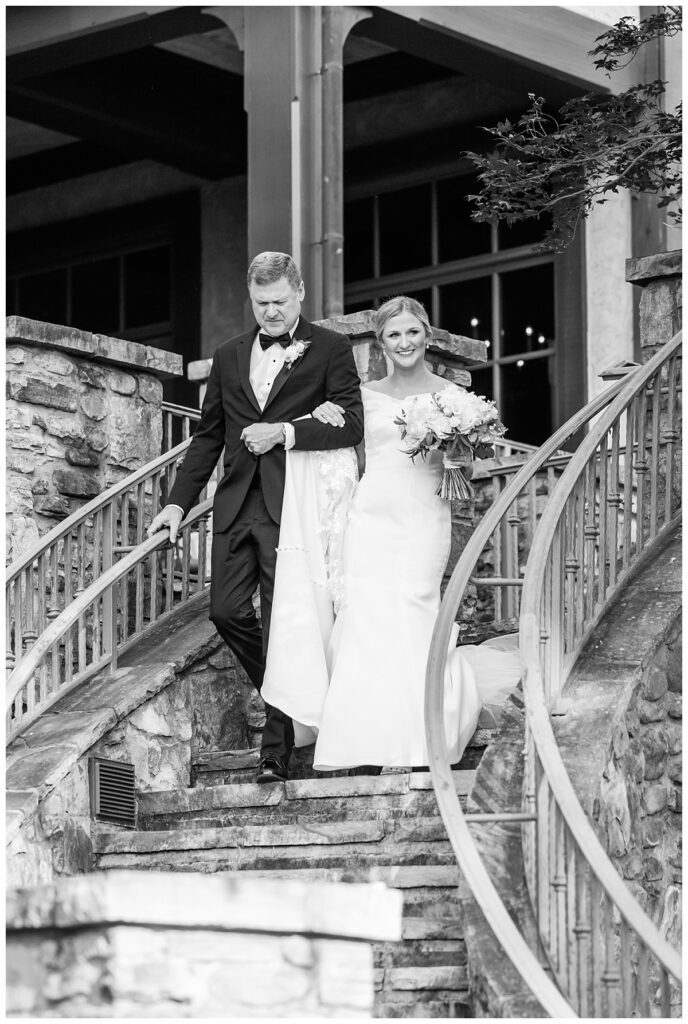 bride and dad on steps at the ledges club in huntsville alabama during wedding ceremony