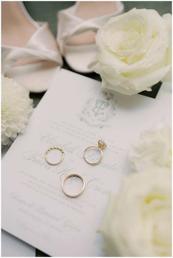 gold wedding bands on sage wedding invitation