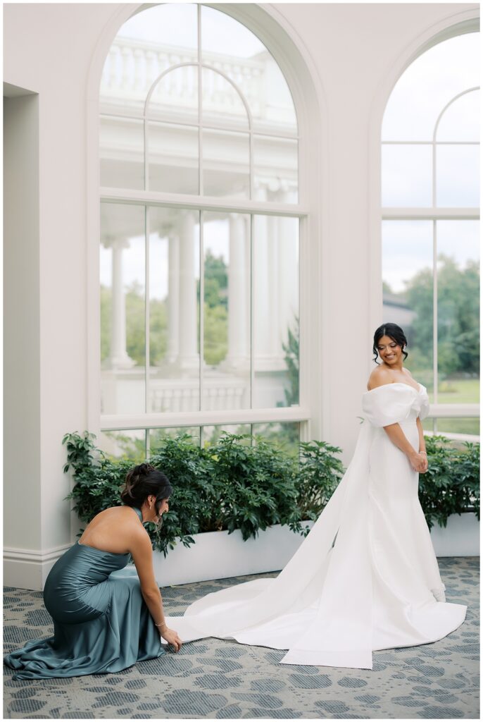 bride getting ready photo with sister helping