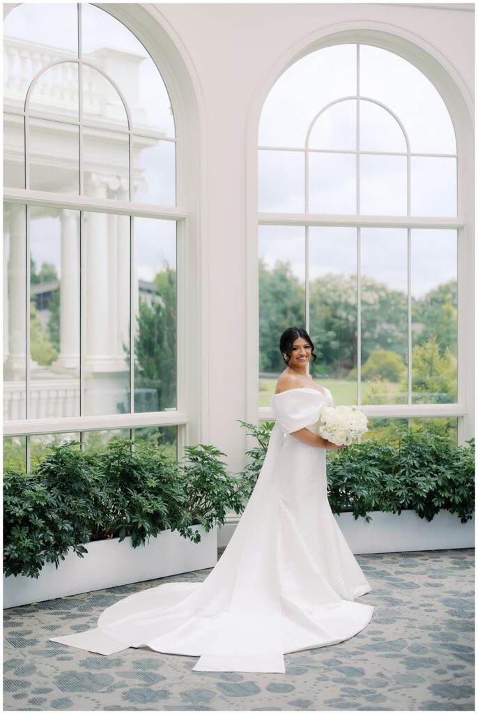 bridal portrait photo with white bouquet and off the shoulder dress