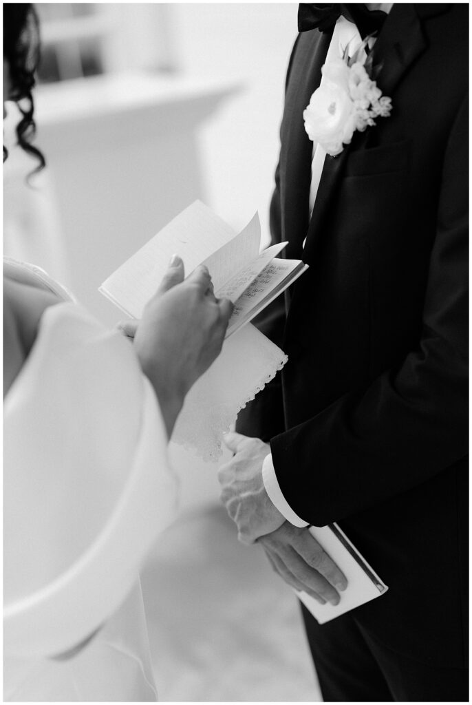 bride and groom reading vows at first look