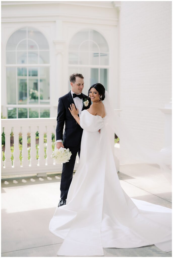 bride and groom picture ideas in botanical gardens with off the shoulder bow dress