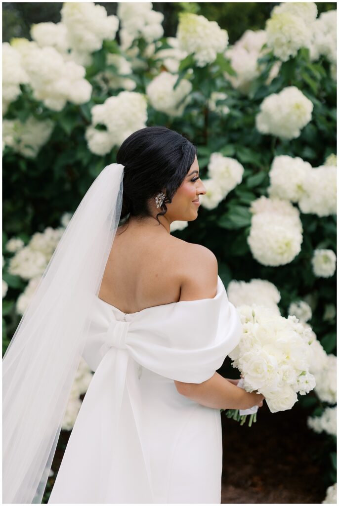 bridal portrait with hydrangeas and bow on back of dress