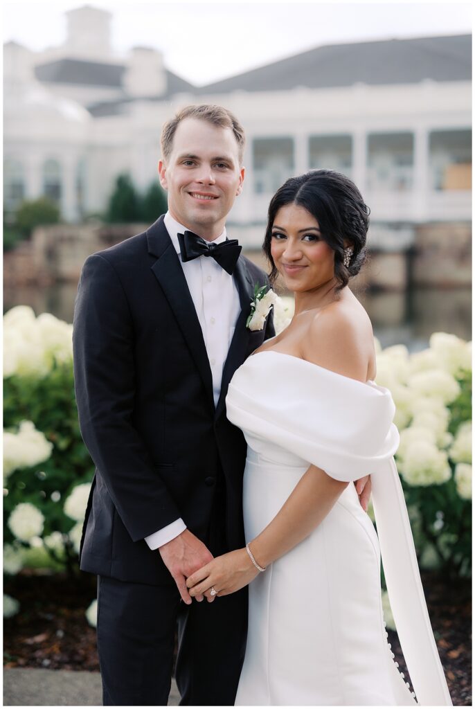 bride and groom picture by hydrangeas at huntsville botanical garden
